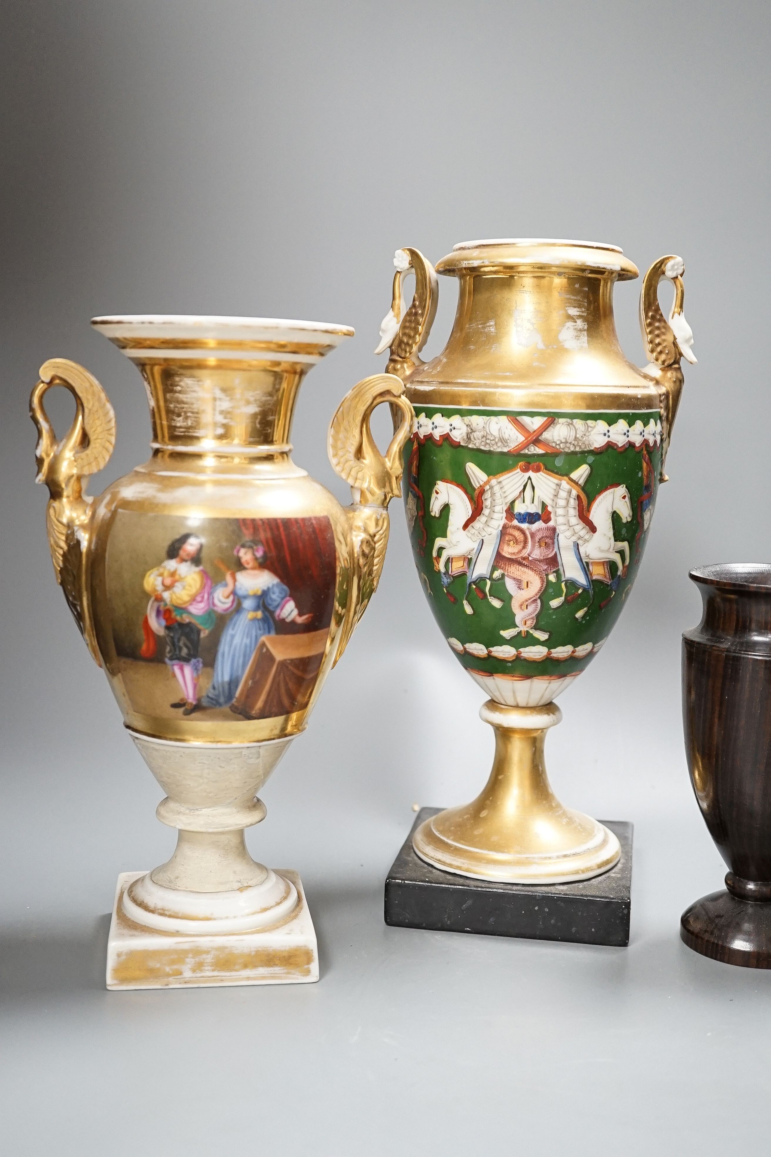 Two 19th century Paris porcelain gilt decorated swan-handled vases and a pair of turned ebony vases, tallest 28cm